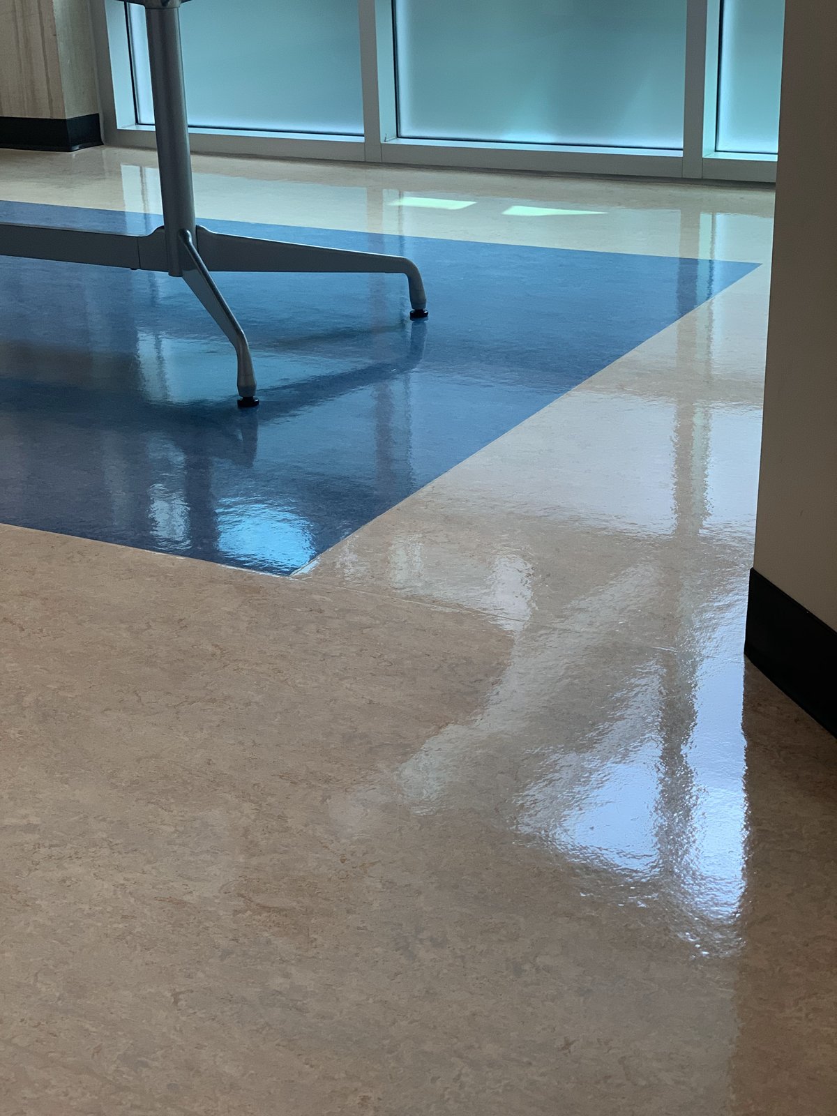 Beige and blue LVT after, with window reflection