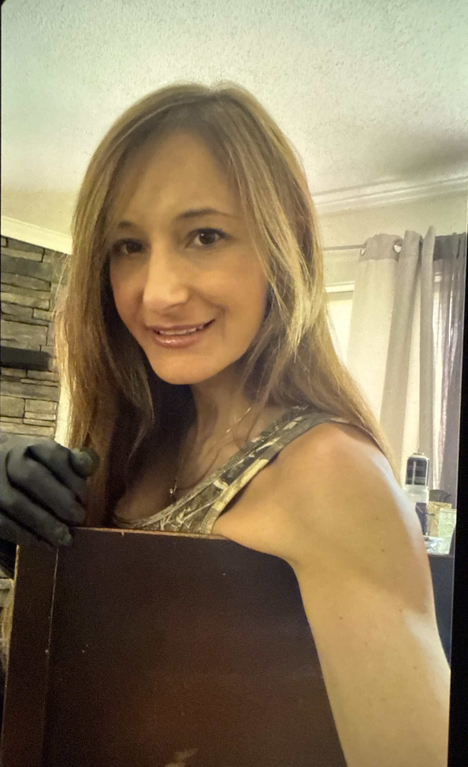Natalie Contro, owner-operator of Contro Floor Revival, on the job in work gloves