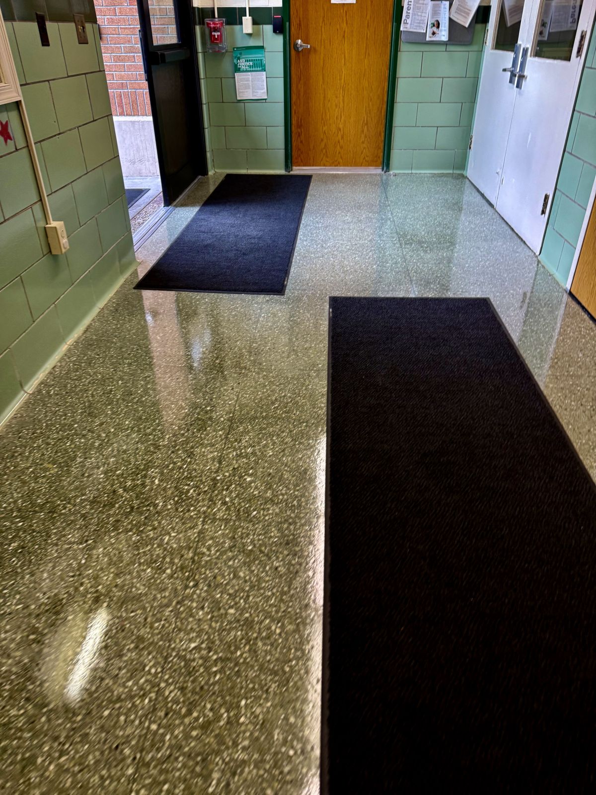 Terrazzo entry vestibule with mats, high-gloss finish