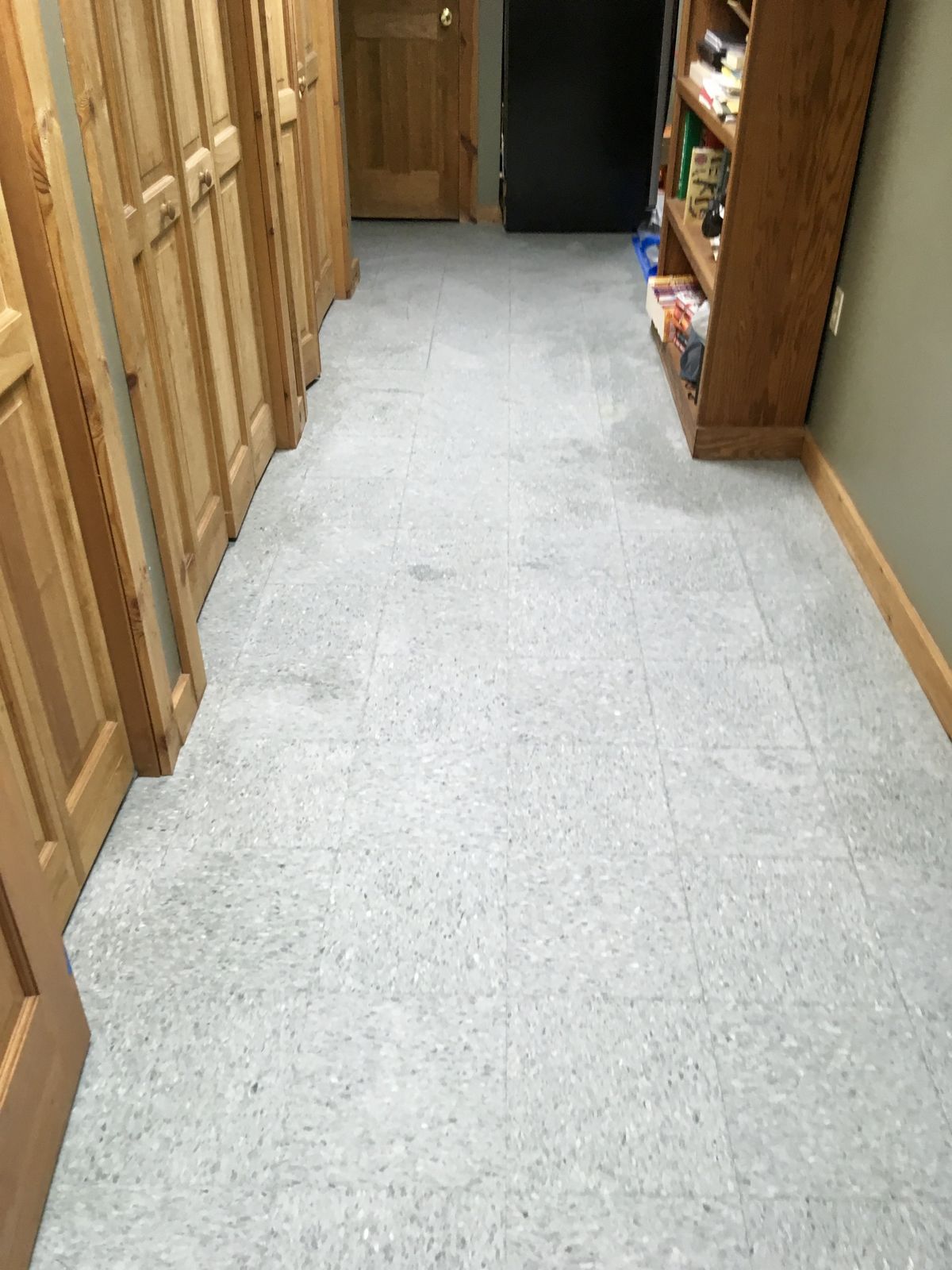 Gray VCT hallway between wood doors