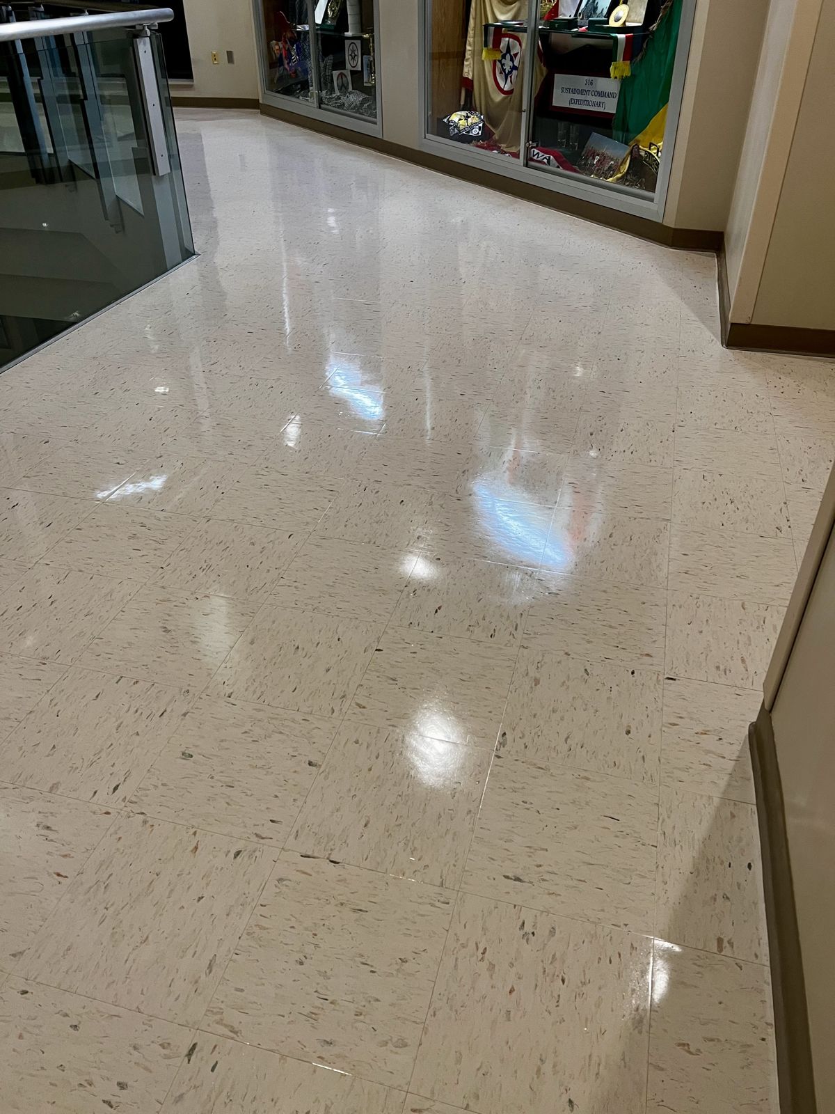 Hallway VCT beside display cases, high-gloss finish