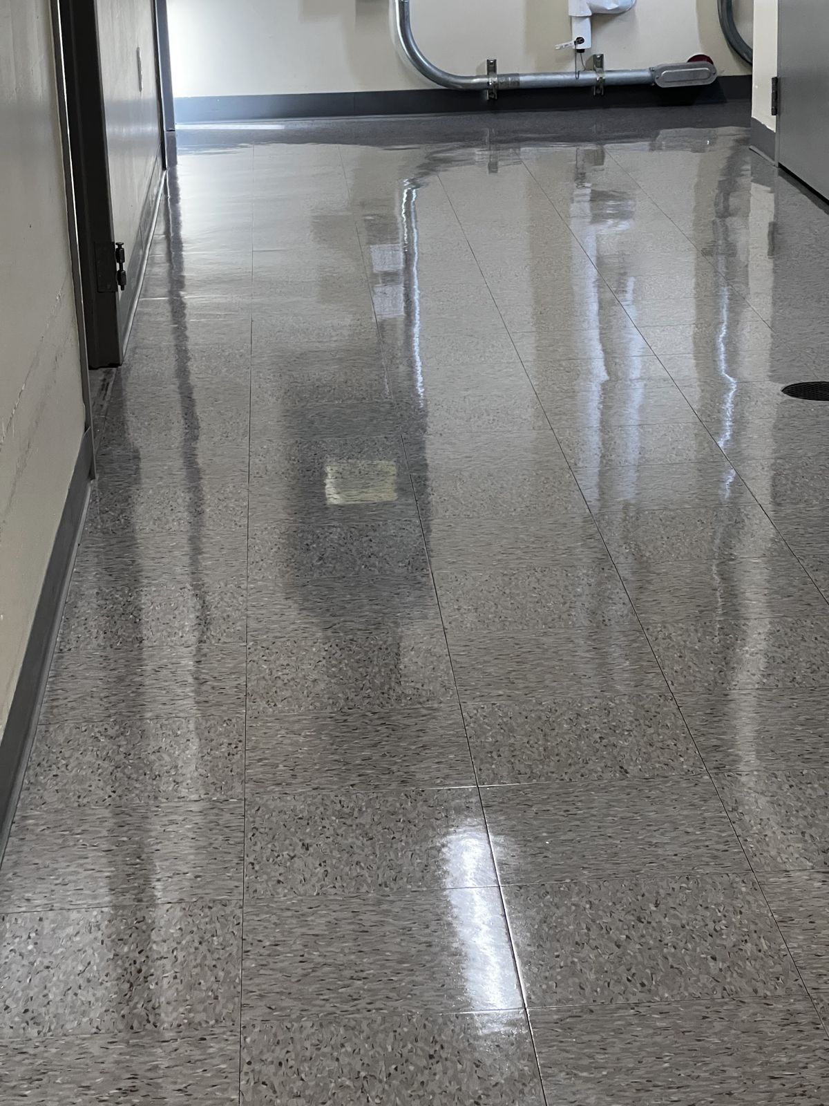 Speckled tile hallway with a high-gloss finish